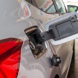 Refueling gasoline at the gas station. gray car